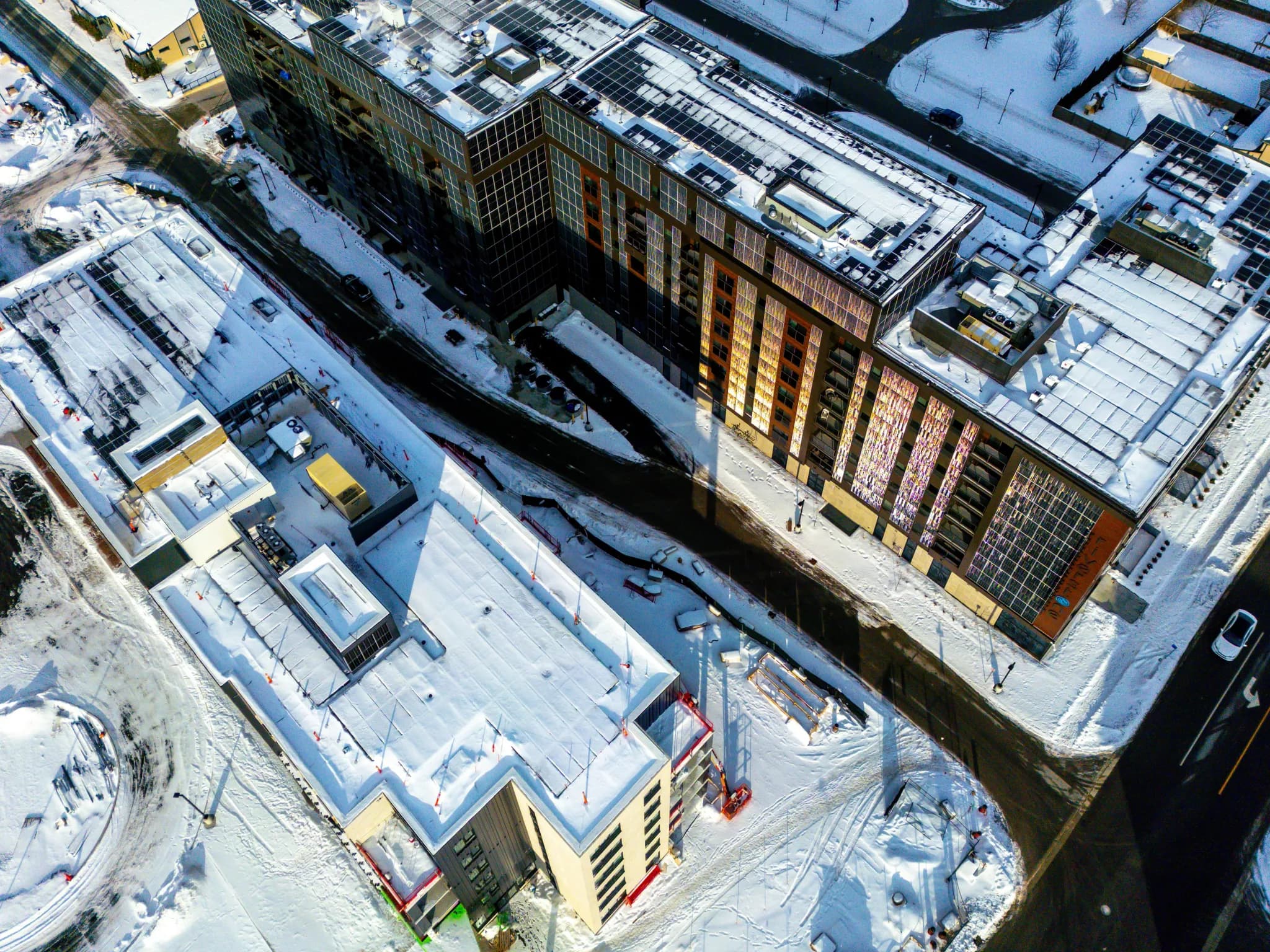 Aerial view of snow-covered buildings and roads.