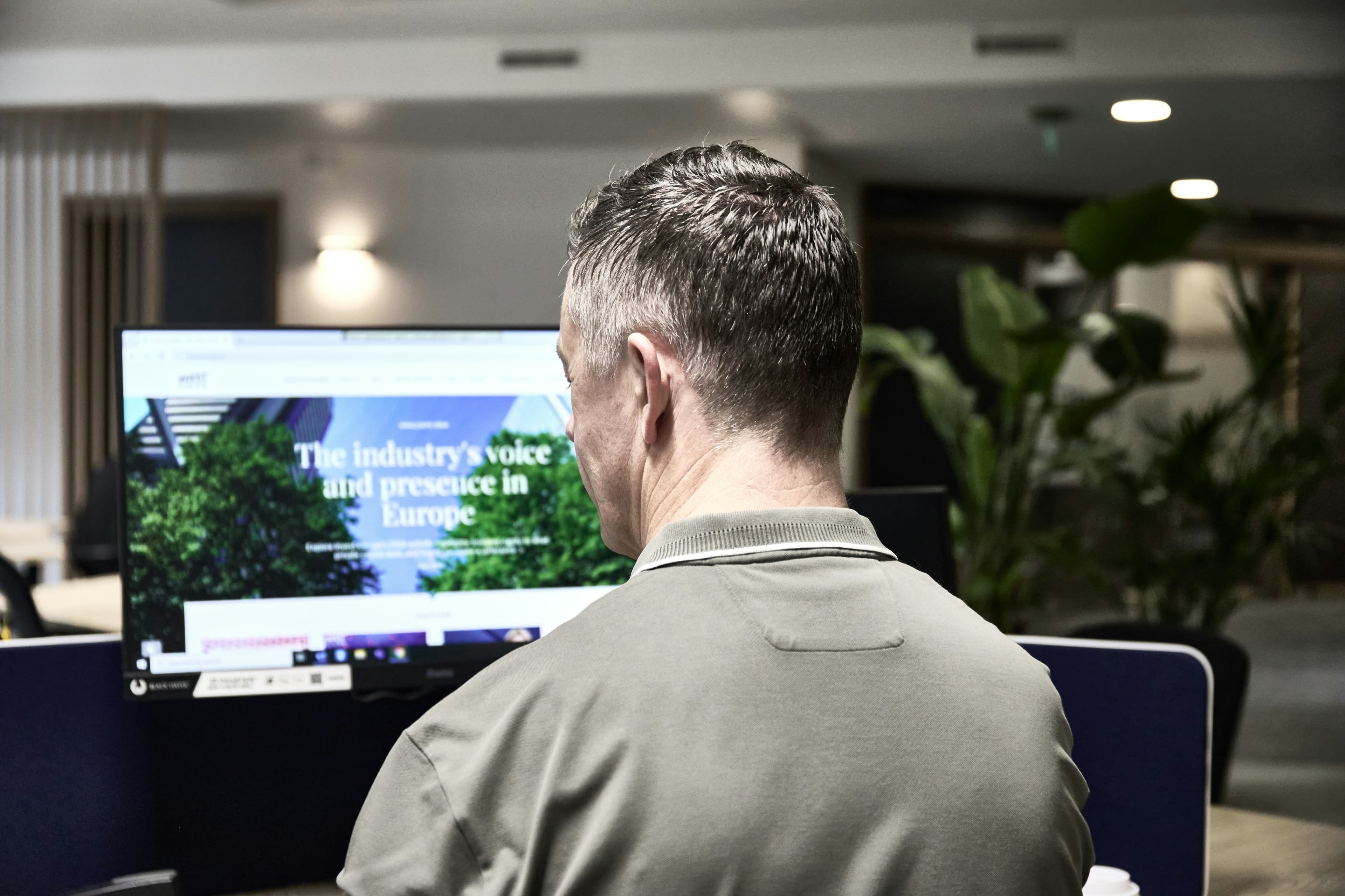 Man working on a computer in an office.