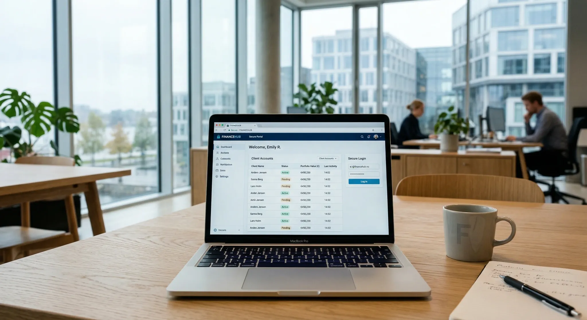 A laptop displaying a clean financial web interface sits on a light wooden desk in a bright, modern office overlooking a city waterfront. The professional setting, punctuated by a coffee mug and a notebook, conveys a focused and contemporary workplace atmosphere.