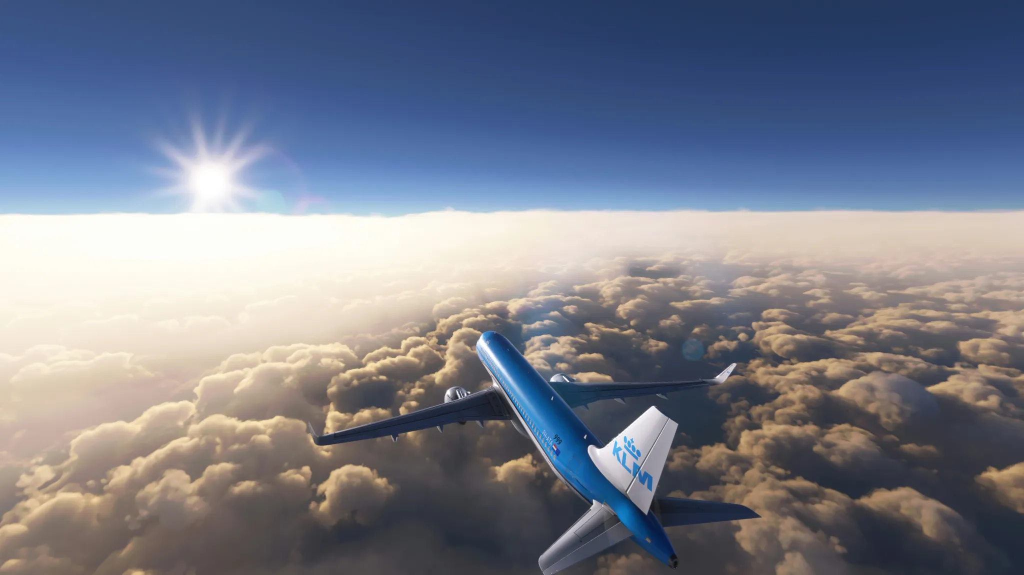 a blue and white jet flying through a cloudy sky