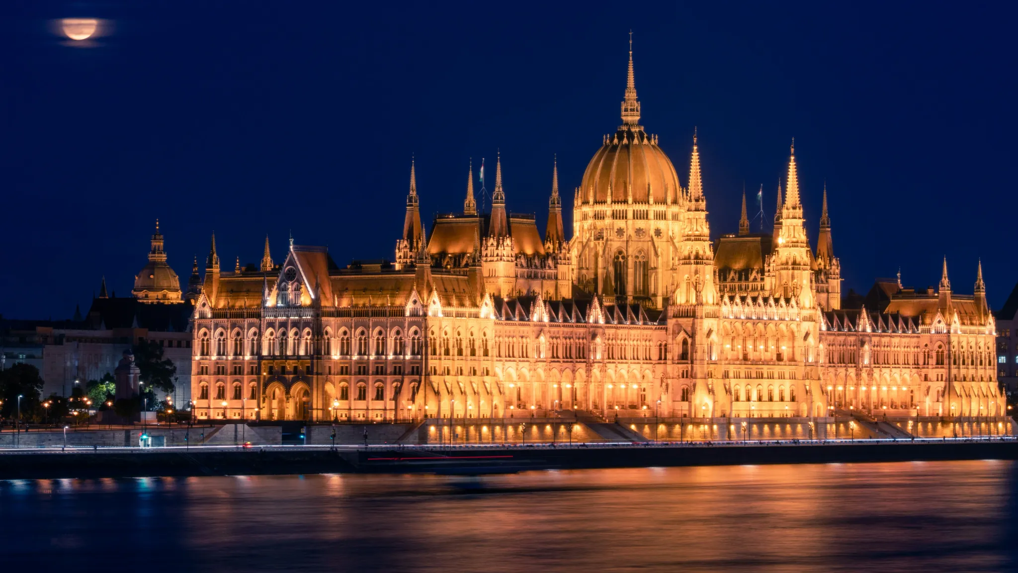 Ornate building illuminated at night with moon