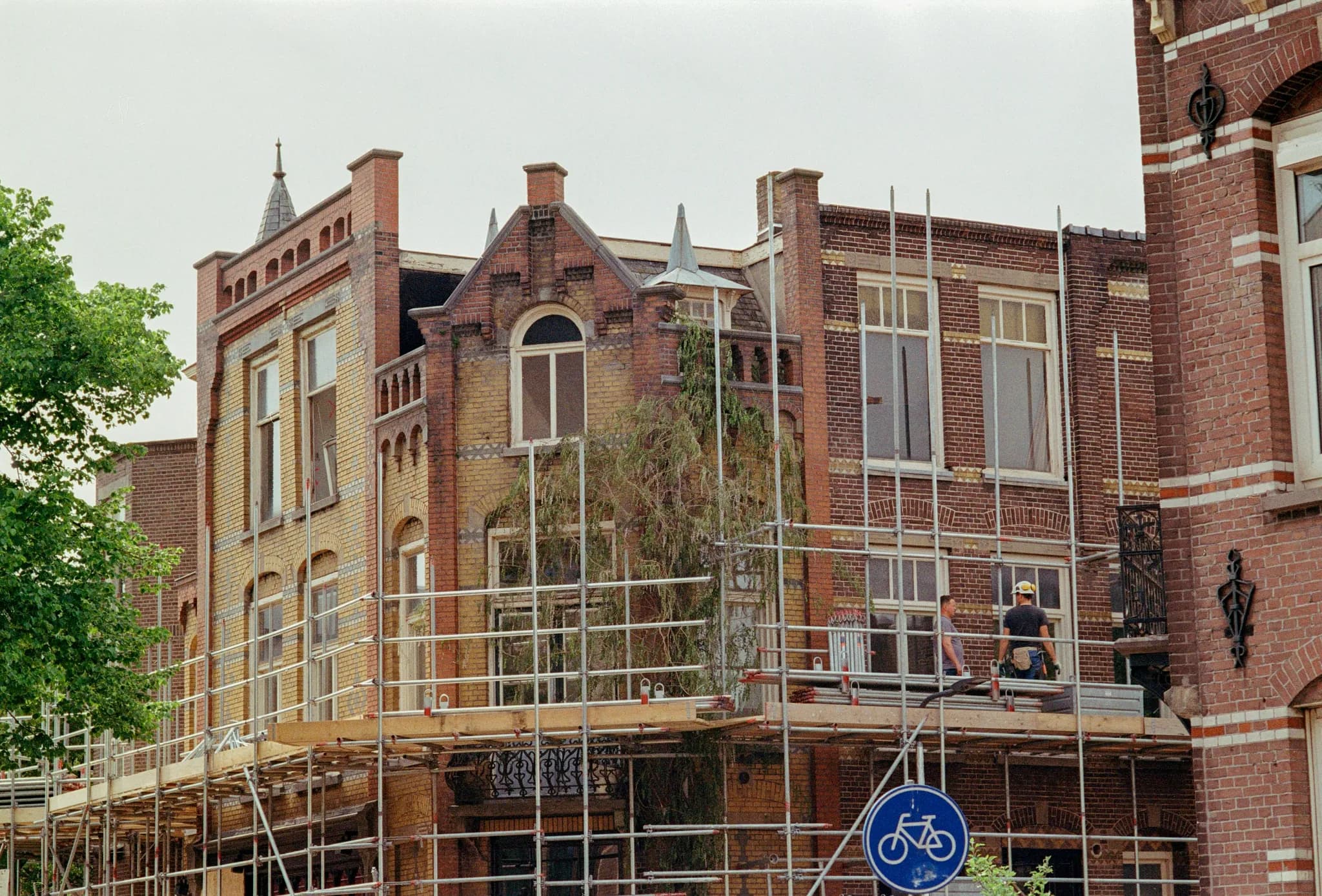 a building with scaffolding around it and a bicycle sign
