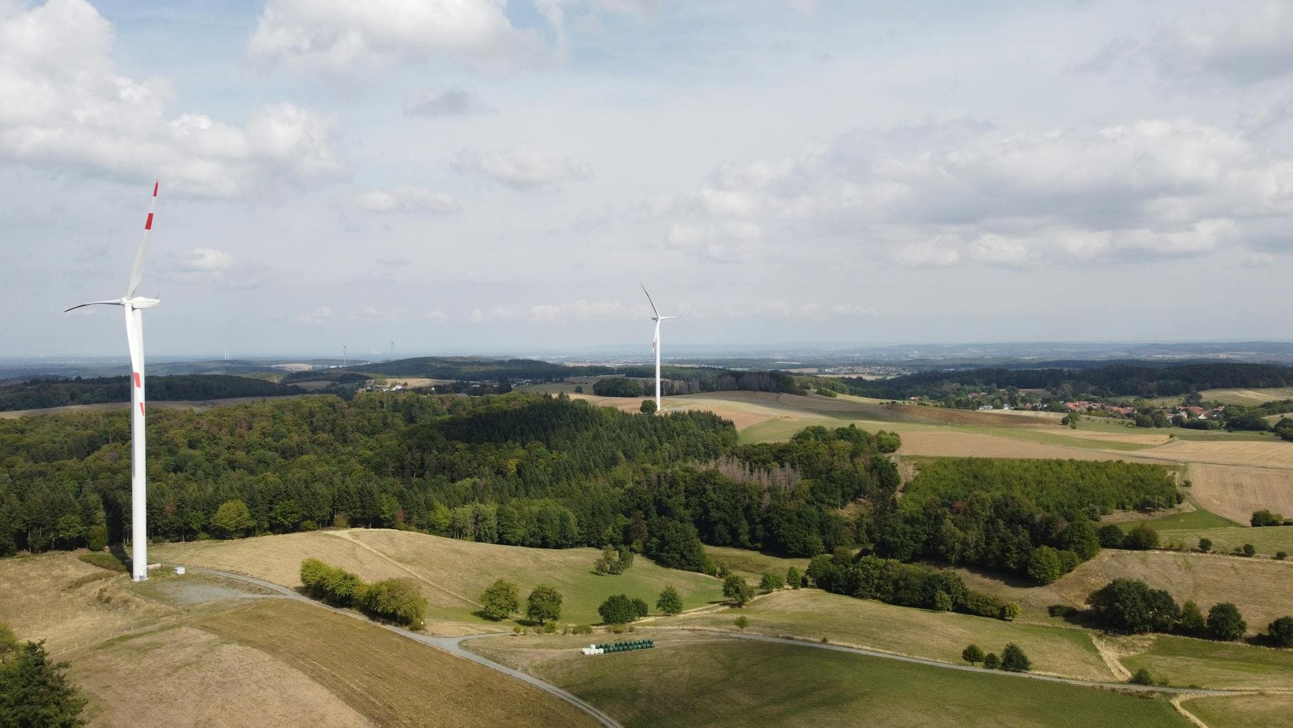 Aerial view of wind turbines and lush fields in Seeheim-Jugenheim, Germany.