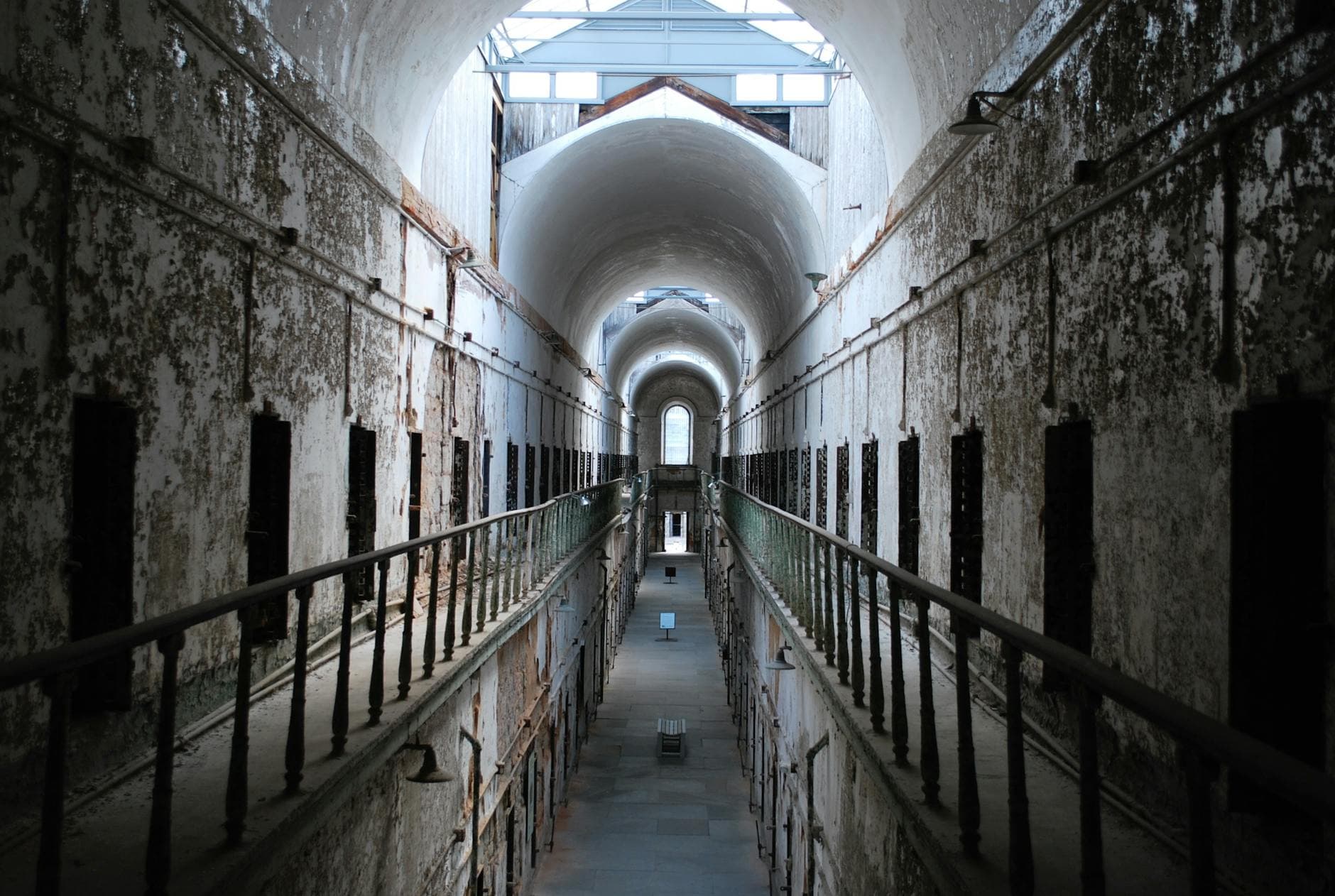 Abandoned hallway of Eastern State Penitentiary in Philadelphia showcasing rustic architecture.