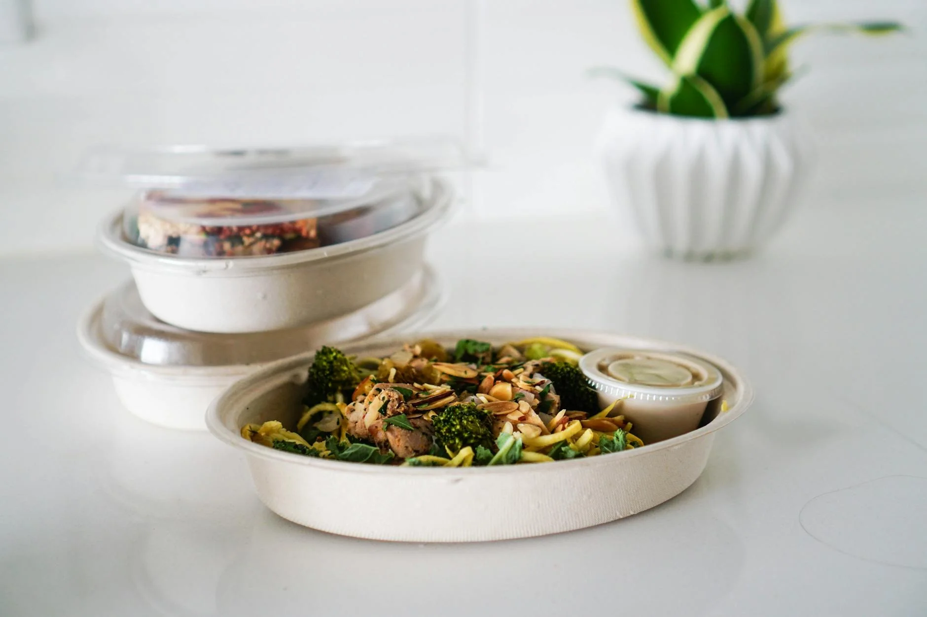A nutritious takeout meal featuring broccoli and seeds, neatly packaged for convenience.
