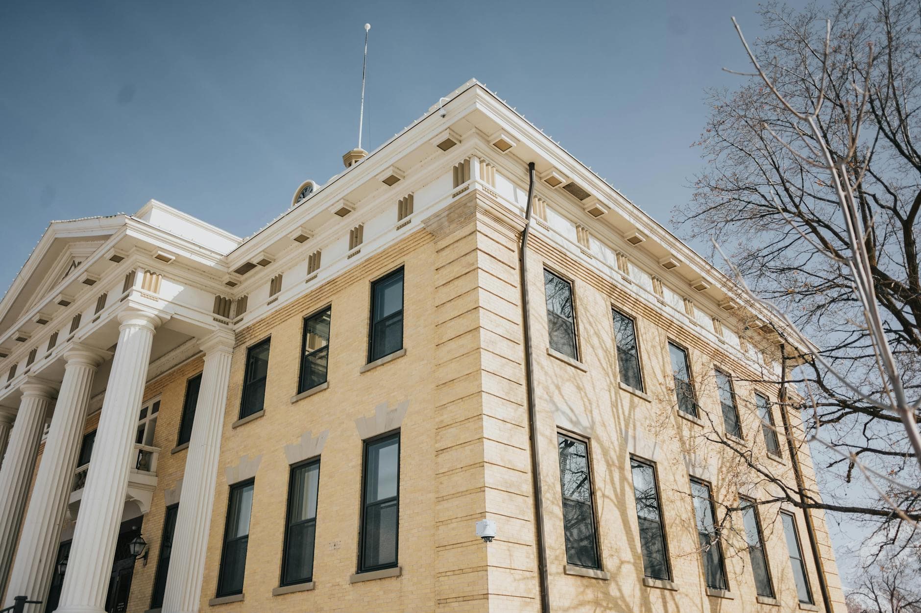 Low angle view of the historic Box Elder County Courthouse with columns and blue sky, Brigham City, Utah.