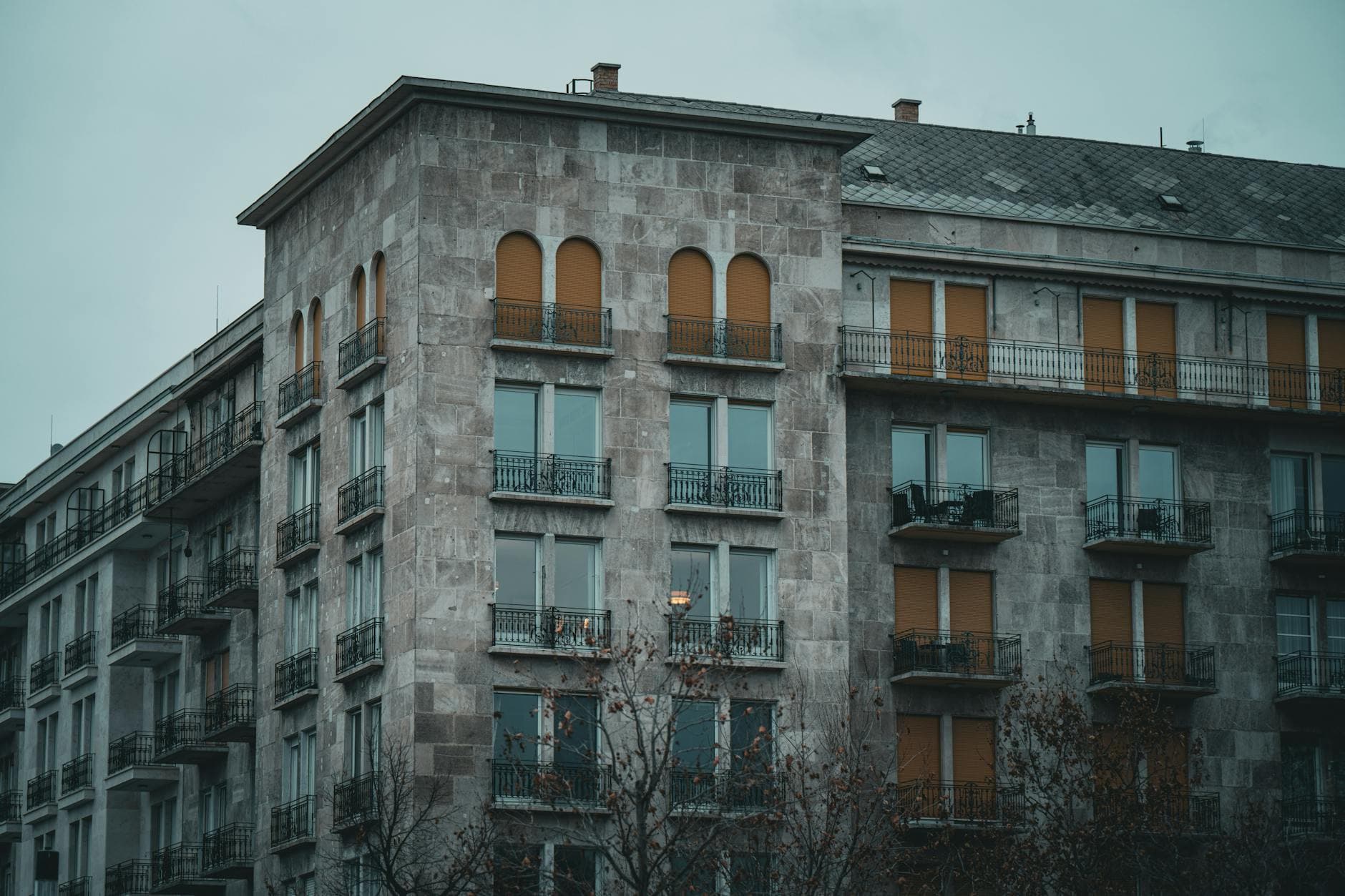 A moody, historic apartment building in Budapest, Hungary with architectural charm.