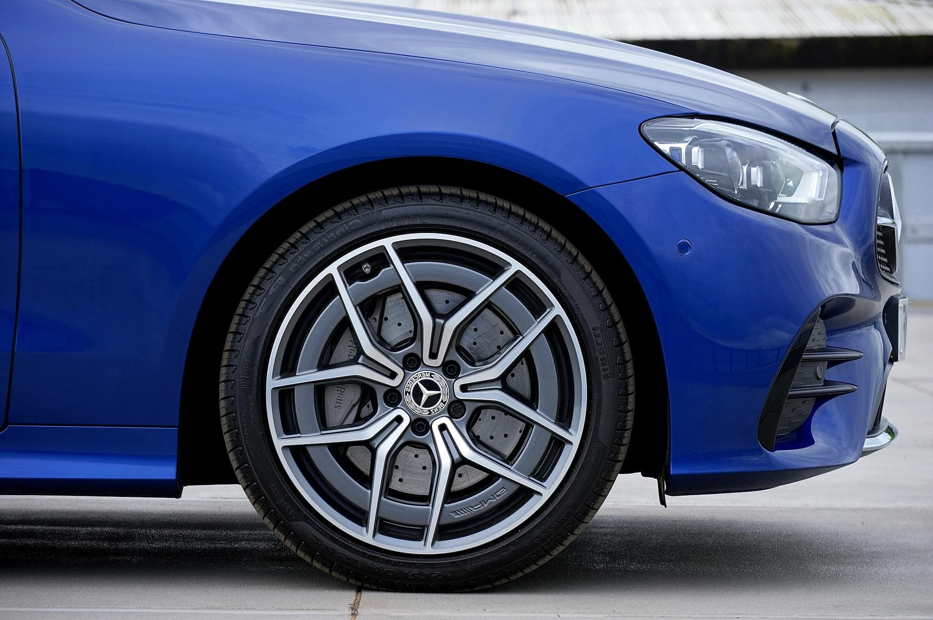 Detailed view of a blue Mercedes-Benz wheel and tire, showcasing alloy design.
