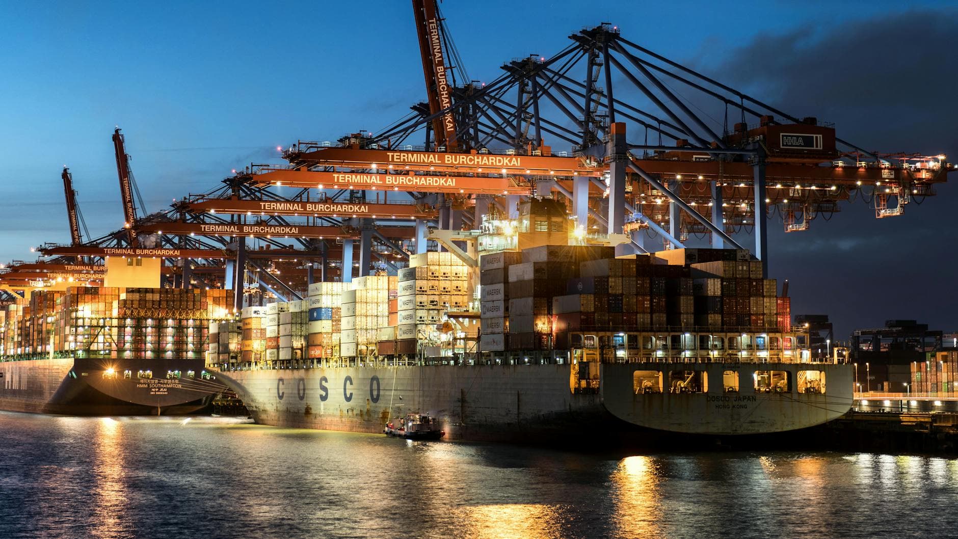 Vibrant evening view of cargo operations at Terminal Burchardkai, Hamburg.