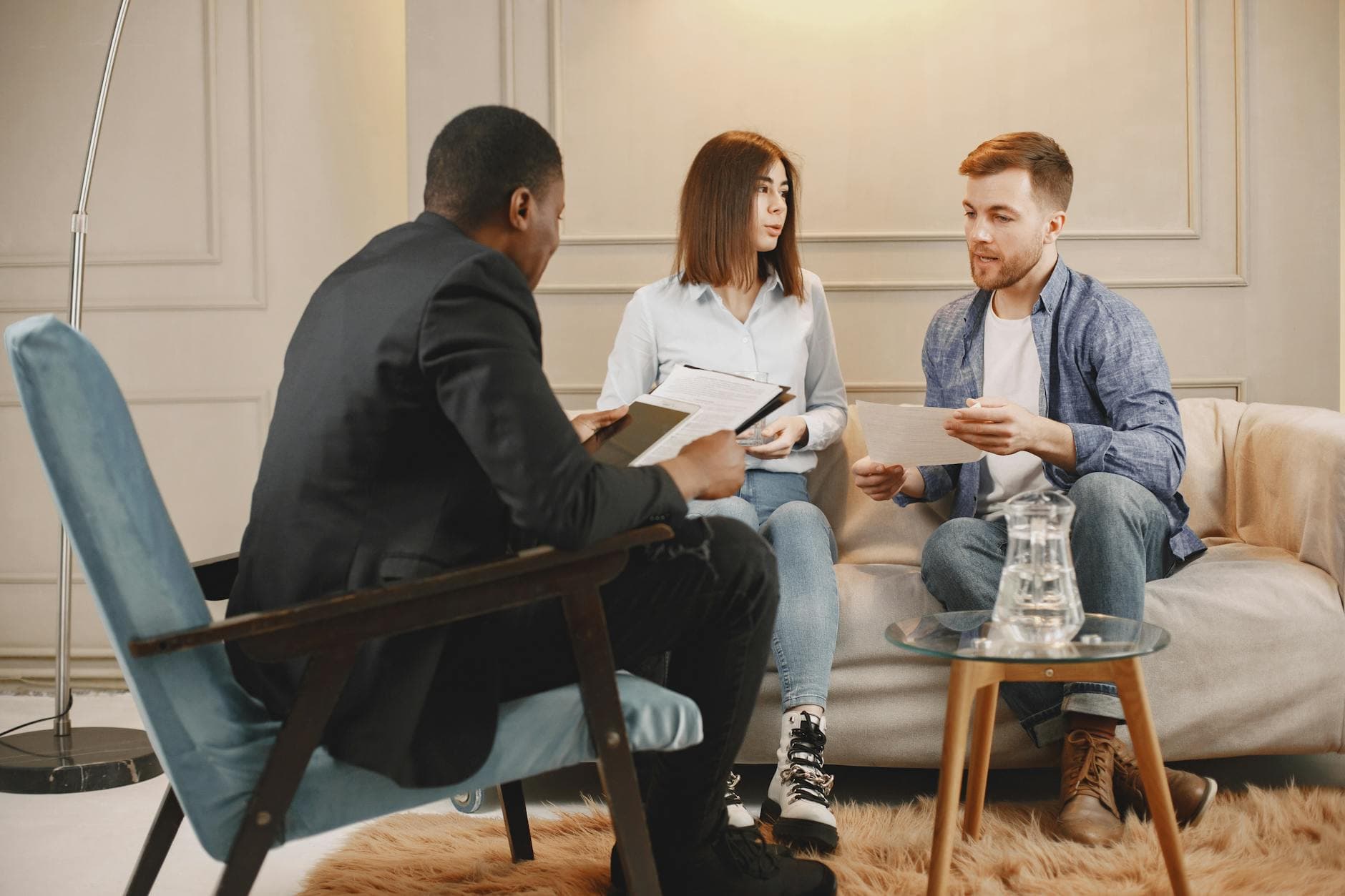 A counseling session with a diverse group of adults discussing issues in a cozy setting.