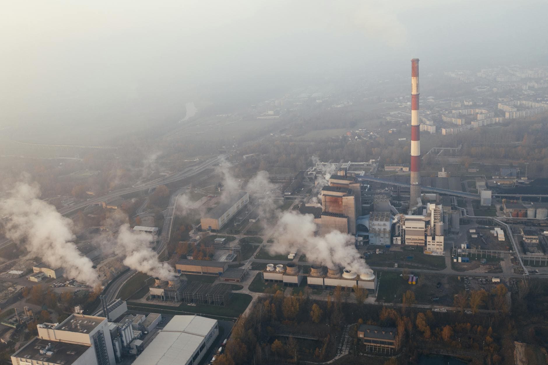 Aerial shot of an industrial plant in Poznań emitting smoke and pollution.