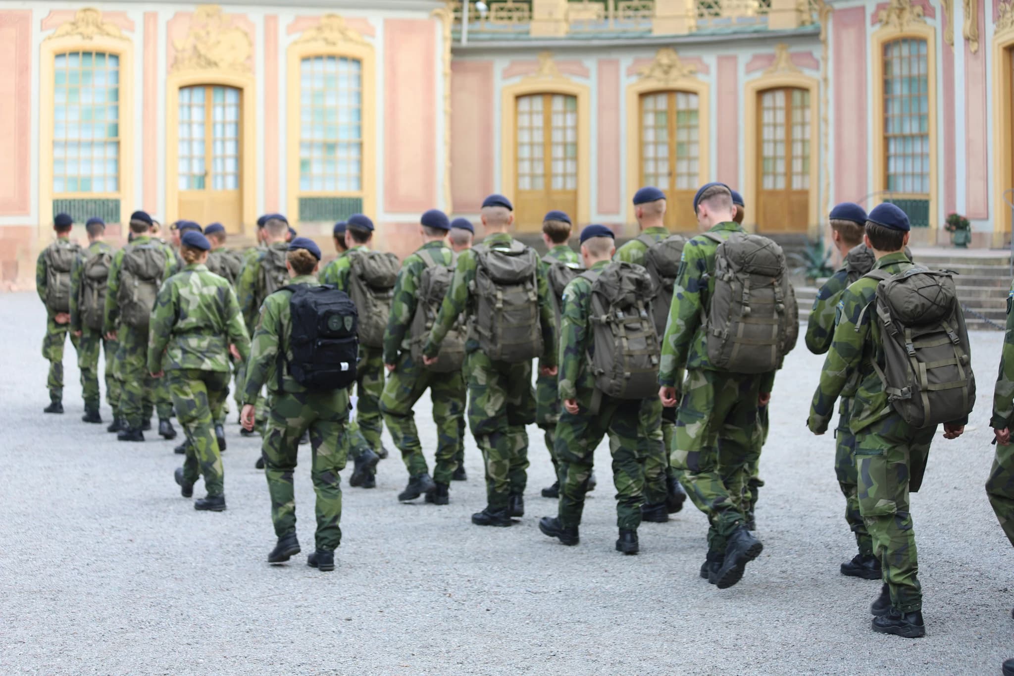 A group of military men walking down a street