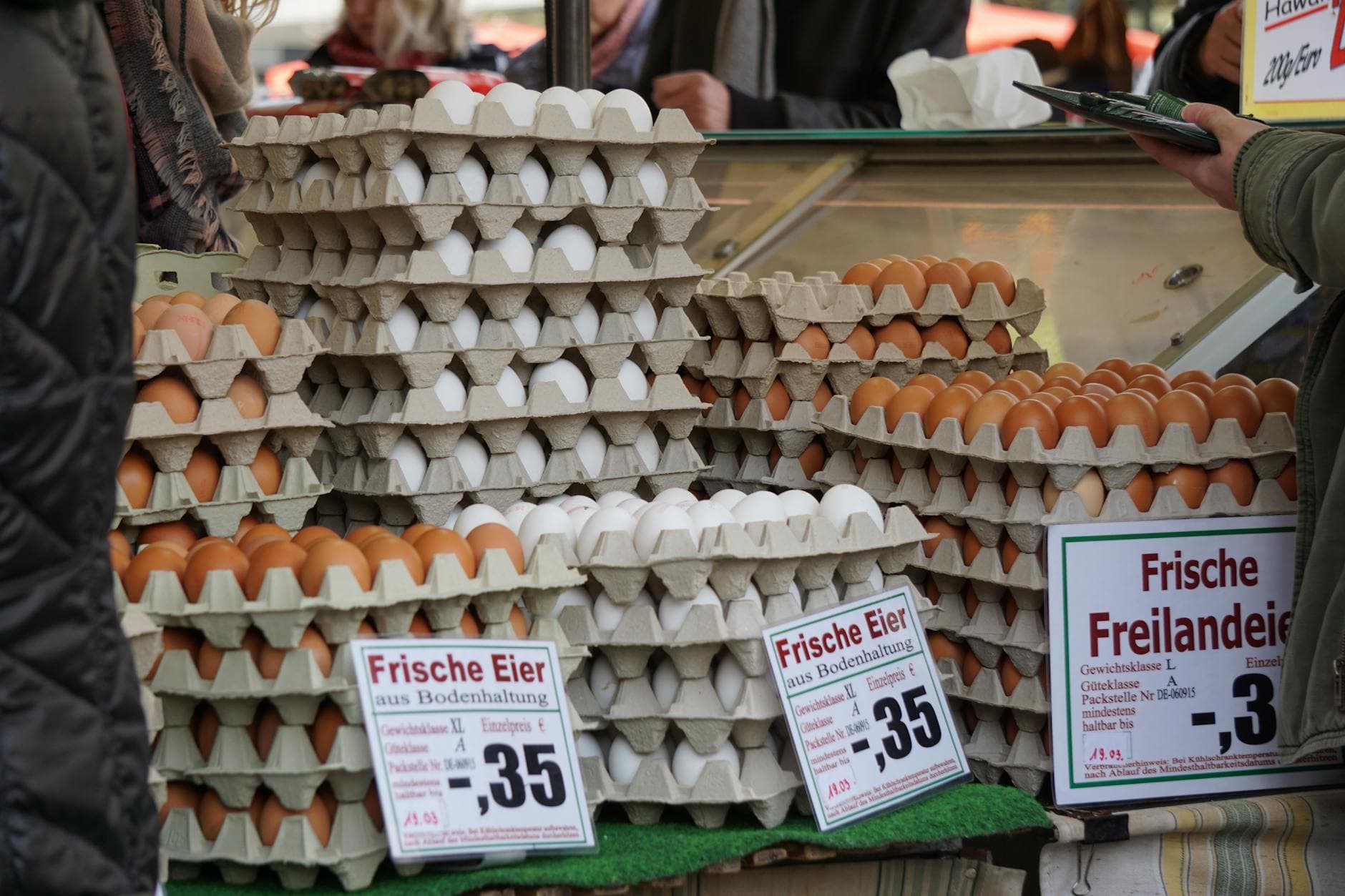 Stacks of fresh eggs in trays on sale at a traditional market in Frankfurt.