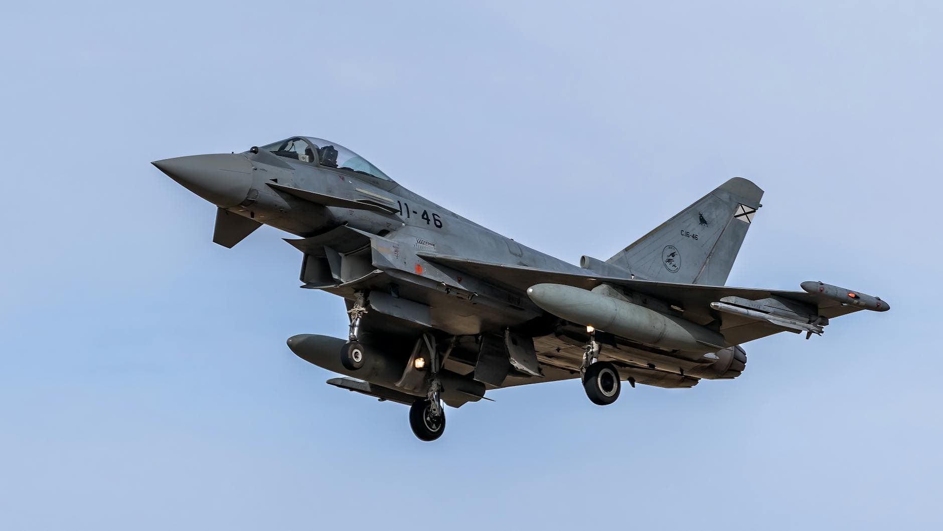 Eurofighter Typhoon jet captured mid-flight in Los Llanos, Spain, showcasing military aviation prowess.